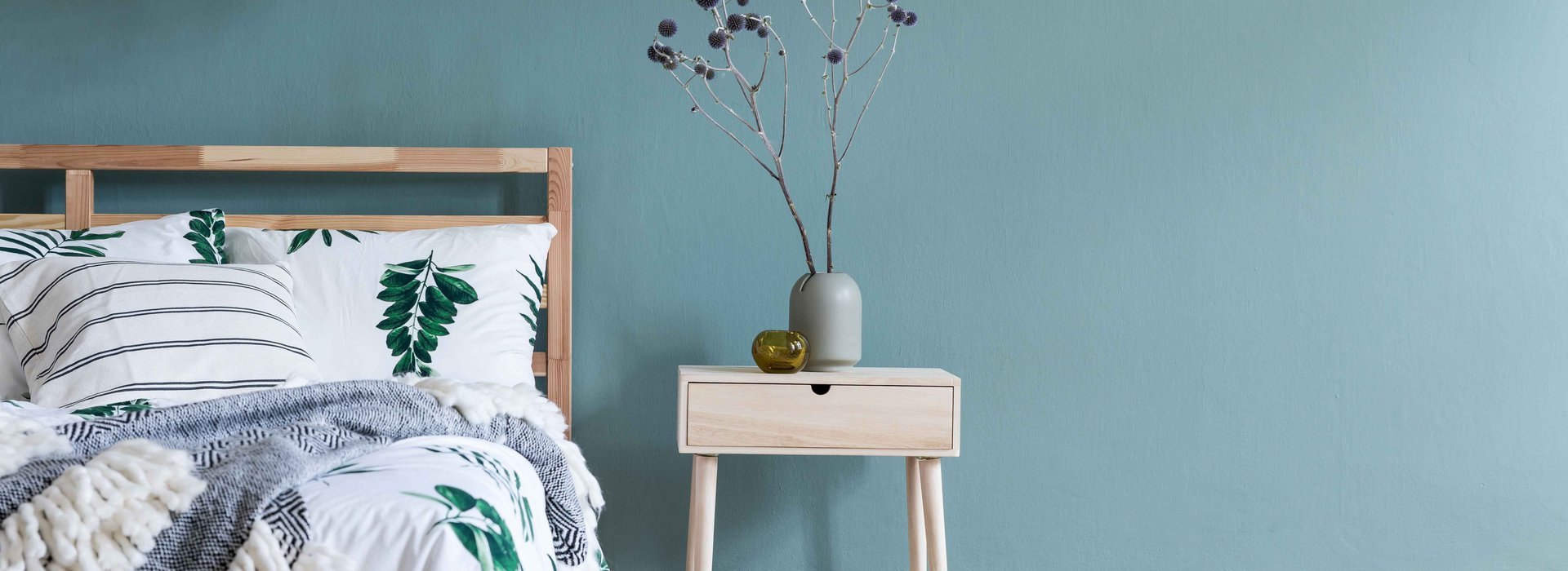 Minimalistic-composition-of-bedroom-interior-with-wooden-bed